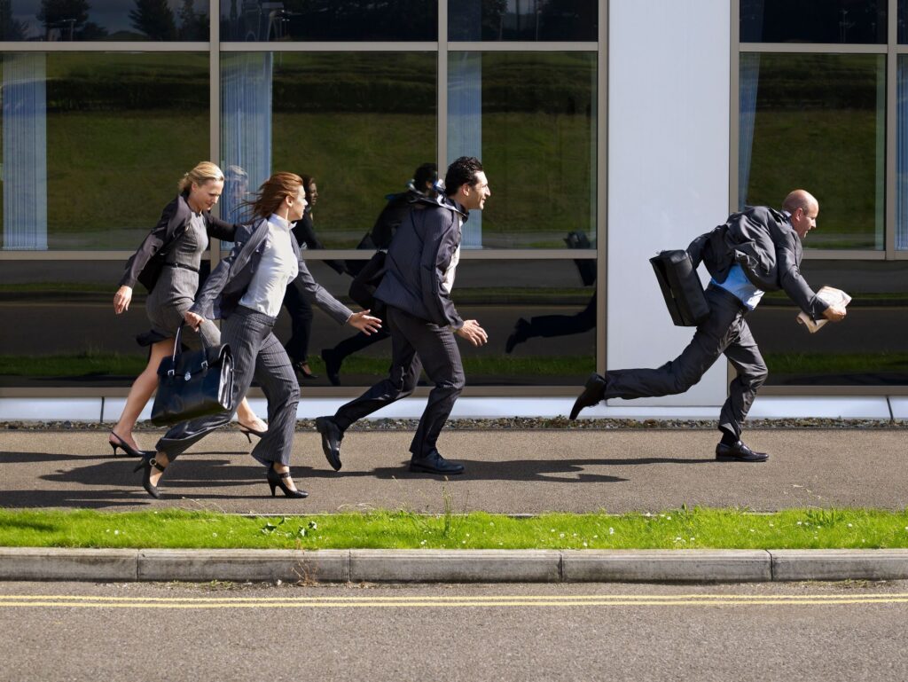 business people fleeing from a building