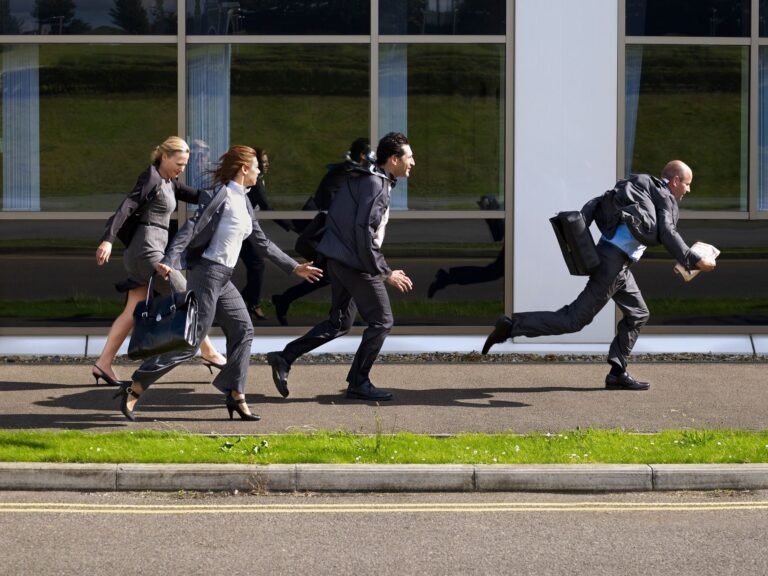 business people fleeing from a building